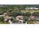 Breathtaking aerial view showcases a large home with manicured landscaping and lush, mature trees in a neighborhood at 5683 Bassett Pl, Sanford, FL 32771
