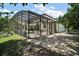 The home's backyard has a screened-in pool, patio, and landscaped area at 5683 Bassett Pl, Sanford, FL 32771