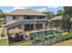 Aerial view of the backyard showcasing the pool, patio, screened enclosure, and landscaping at 5683 Bassett Pl, Sanford, FL 32771