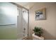 Bathroom featuring a shower-tub combo with glass doors and neutral decor at 5683 Bassett Pl, Sanford, FL 32771