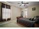 Comfortable bedroom with a wooden bed frame, carpeted floors, and lots of natural light at 5683 Bassett Pl, Sanford, FL 32771
