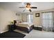 Well-lit bedroom featuring a ceiling fan and tasteful curtains at 5683 Bassett Pl, Sanford, FL 32771