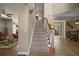Grand foyer with a staircase, high ceilings, and an open floor plan leading to the living and dining areas at 5683 Bassett Pl, Sanford, FL 32771