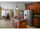 Open-concept kitchen with stainless steel appliances, a central island, and seamless access to the dining and living areas at 5683 Bassett Pl, Sanford, FL 32771