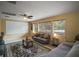 Comfortable living room featuring neutral colors, a ceiling fan and natural light from multiple windows at 5683 Bassett Pl, Sanford, FL 32771