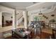 Open-concept living room with hardwood floors, an elegant staircase, and seamless flow to dining area at 5683 Bassett Pl, Sanford, FL 32771