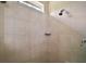 Tiled shower with bronze shower head, corner shelf, and small garden window at 5683 Bassett Pl, Sanford, FL 32771