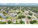 Aerial shot displays a residential community featuring green spaces, tranquil ponds, and manicured lawns at 7469 Hunters Greene Cir, Lakeland, FL 33810