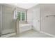 Bright bathroom featuring a tub and shower, along with a window at 7469 Hunters Greene Cir, Lakeland, FL 33810