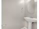 Powder room featuring a pedestal sink and round mirror at 7469 Hunters Greene Cir, Lakeland, FL 33810