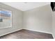 Bright bedroom featuring wood floors and a window for natural light at 7469 Hunters Greene Cir, Lakeland, FL 33810