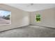 Bright bedroom with two windows and neutral carpeting at 7469 Hunters Greene Cir, Lakeland, FL 33810