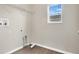 Practical laundry room with window, shelving and modern hookups at 7469 Hunters Greene Cir, Lakeland, FL 33810