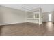 Bright living room featuring laminate flooring, neutral walls, and an exterior door at 7469 Hunters Greene Cir, Lakeland, FL 33810