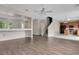 Open-concept living room with tile flooring, laminate flooring, staircase, and natural light at 7469 Hunters Greene Cir, Lakeland, FL 33810