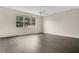 Spacious living room featuring laminate flooring, neutral walls, and a large window at 7469 Hunters Greene Cir, Lakeland, FL 33810