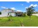 Beautifully landscaped backyard and screened in patio provide ample outdoor enjoyment at 816 Carmillion Ct, Groveland, FL 34736