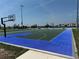 Community basketball court featuring blue and green playing surface, black hoops, and modern lighting at 816 Carmillion Ct, Groveland, FL 34736