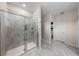 Modern bathroom with tiled shower, glass door, and neutral color scheme at 816 Carmillion Ct, Groveland, FL 34736