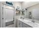 Bright bathroom with double sinks, white cabinets, and a separate toilet and shower area at 816 Carmillion Ct, Groveland, FL 34736