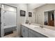 Double vanity bathroom, walk in shower, framed mirrors, and bright vanity lighting at 816 Carmillion Ct, Groveland, FL 34736