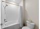 Bright bathroom featuring a shower over tub and white tiling at 816 Carmillion Ct, Groveland, FL 34736