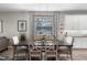 Charming dining area featuring a modern light fixture, a dark wood table and kitchen view at 816 Carmillion Ct, Groveland, FL 34736