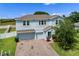 Charming two-story home with a two car garage, beautiful brick driveway and manicured landscaping at 816 Carmillion Ct, Groveland, FL 34736