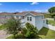 Two-story home with a blue exterior, a well-maintained lawn, and mature trees at 816 Carmillion Ct, Groveland, FL 34736