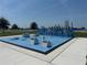 Modern outdoor fitness area featuring blue equipment, concrete walkways, and easy access to recreational amenities at 816 Carmillion Ct, Groveland, FL 34736