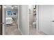 Hallway view leading to the primary bedroom, with a glimpse of a conveniently located half bathroom at 816 Carmillion Ct, Groveland, FL 34736