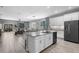 Modern kitchen with an island, stainless steel appliances and an open floor plan leading to living room at 816 Carmillion Ct, Groveland, FL 34736