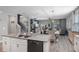 Modern kitchen with an island, stainless steel appliances and an open floor plan leading to living room at 816 Carmillion Ct, Groveland, FL 34736
