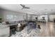 Spacious living room with an open floor plan, wood-look tile flooring, and plenty of natural light at 816 Carmillion Ct, Groveland, FL 34736