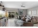 Comfortable living room with neutral tones, large sectional sofa, and sliding glass doors to the patio at 816 Carmillion Ct, Groveland, FL 34736