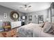 A luxurious main bedroom with a decorative mirror, soft rug and fan at 816 Carmillion Ct, Groveland, FL 34736