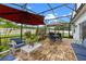 Covered patio with outdoor furniture and decor, offering a relaxing space to enjoy the backyard view at 816 Carmillion Ct, Groveland, FL 34736