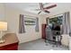Nicely sized bedroom featuring natural light, ceiling fan, neutral decor, and an accent chair at 911 Ursula St, Ocoee, FL 34761