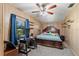 Bedroom with a comfortable bed, wood paneled walls, and a ceiling fan at 911 Ursula St, Ocoee, FL 34761