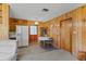 Cozy dining area with wood paneling, a quaint table setting, and easy access to the kitchen at 911 Ursula St, Ocoee, FL 34761