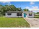 Charming one-story home with a well-maintained lawn and a bright teal front door at 911 Ursula St, Ocoee, FL 34761
