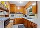 Functional kitchen featuring wood cabinetry, white appliances, and a convenient layout at 911 Ursula St, Ocoee, FL 34761