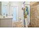 This bathroom features a tiled shower, white cabinets, and a door to the backyard at 1012 W New Hampshire St, Orlando, FL 32804
