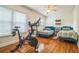 Bright bedroom with hardwood floors, two twin beds, and a Peloton exercise bike at 1012 W New Hampshire St, Orlando, FL 32804