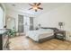 Comfortable bedroom with neutral walls, tile floor, ceiling fan and a large window with natural light at 1012 W New Hampshire St, Orlando, FL 32804