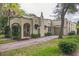 Beautiful stucco home featuring a covered porch, arched details, and a private driveway at 1012 W New Hampshire St, Orlando, FL 32804