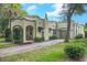 Charming single-story home with stucco exterior, arched entry, chimney, and a brick driveway leading to an attached garage at 1012 W New Hampshire St, Orlando, FL 32804