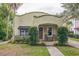 Charming stucco home with a brick walkway, covered porch, and lush landscaping at 1012 W New Hampshire St, Orlando, FL 32804