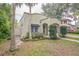 Charming stucco home featuring a covered porch and mature trees at 1012 W New Hampshire St, Orlando, FL 32804