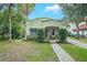 Beautiful craftsman home boasting mature landscaping and a brick walkway leading to a covered porch with rocking chairs at 1012 W New Hampshire St, Orlando, FL 32804